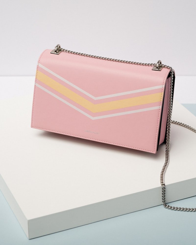 Blush pink flap handbag with silver chain shoulder strap